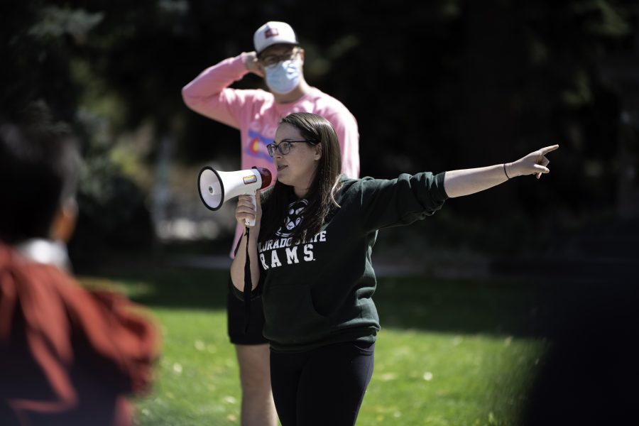 Natalie Buchholz points to the Colorado State University Administrative Building calling upon President Joyce McConnell to handle instances of controversy “better” in the future. Buchholz is speaking as a member of the Call Out CSU protestors who have organized against controversial discussion on campus Sept. 17.(Garrett Mogel | The Collegian)