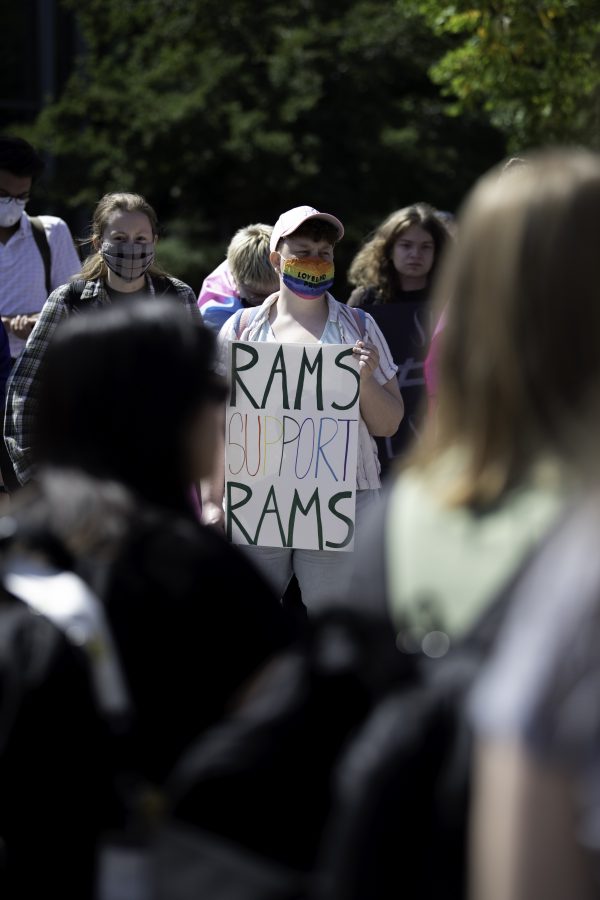 Shiloh Dailey displays one of Colorado State University’s Principals of Community  on the Plaza at Call Out CSU protest Sept. 17. (Garrett Mogel | The Collegian)