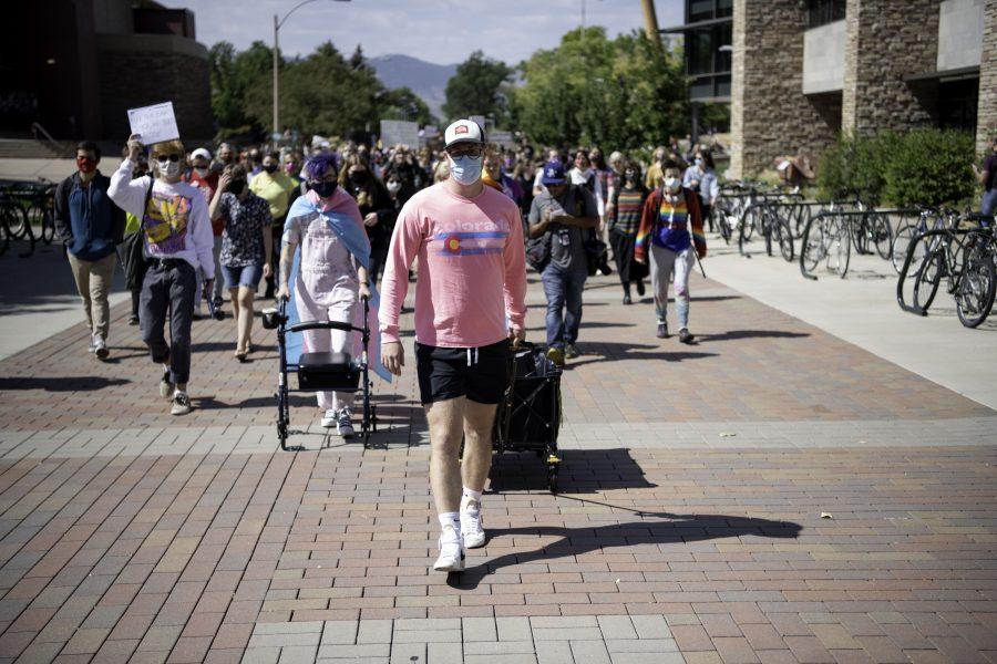 Ty Smith leads Call Out CSU protestors across the Colorado State University Plaza toward the Oval. Sept. 17. (Garrett Mogel | The Collegian)