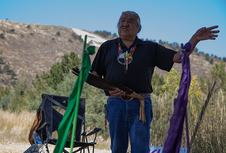 Kenny Frost, a spiritual leader for Indigenous tribes, gestures to the people present at a press conference held by the Hughes Land Back initiative in Fort Collins Sept. 18, 2021. Hughes Land Bank organized the press conference at the site of a deconstructed sweat lodge in place of the ceremony they originally planned. (Serena Bettis | The Collegian)
