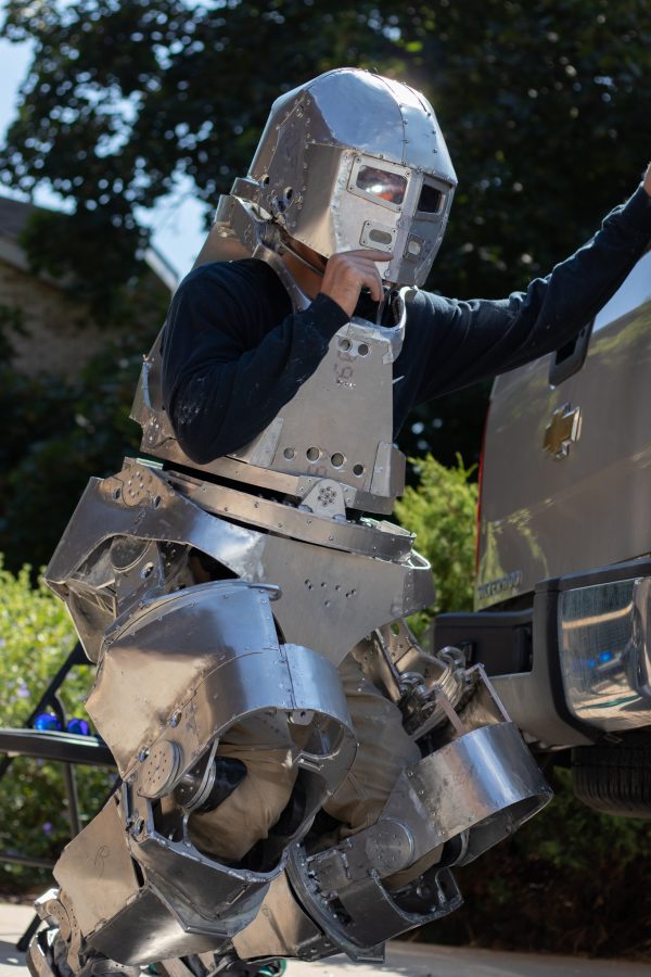 Dylan Edmiston demonstrates the mobility of his Mark I Iron Man suit through a flexibility demonstration Sept. 19. The suit twists at the waist and head while bending at the knees and ankles simultaneously supporting its own weight through the frame rather than the pilot’s skeleton. (Grayson Reed | The Collegian)