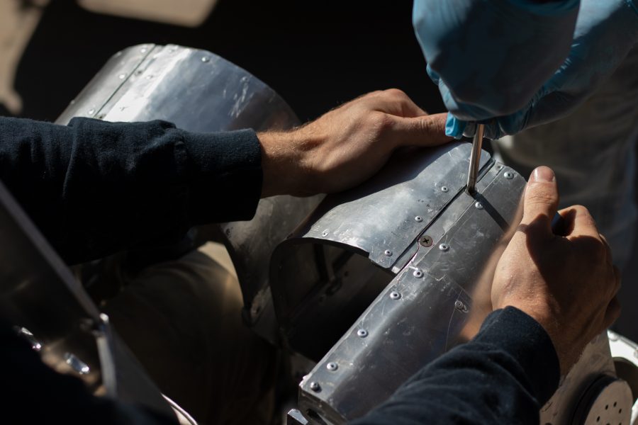 Dylan Edmiston gets bolted into his Mark I Iron Man suit by his father Robin Edmiston Sept. 19. From start to finish it takes roughly 30 minutes to get into the suit of metal. (Grayson Reed | The Collegian)