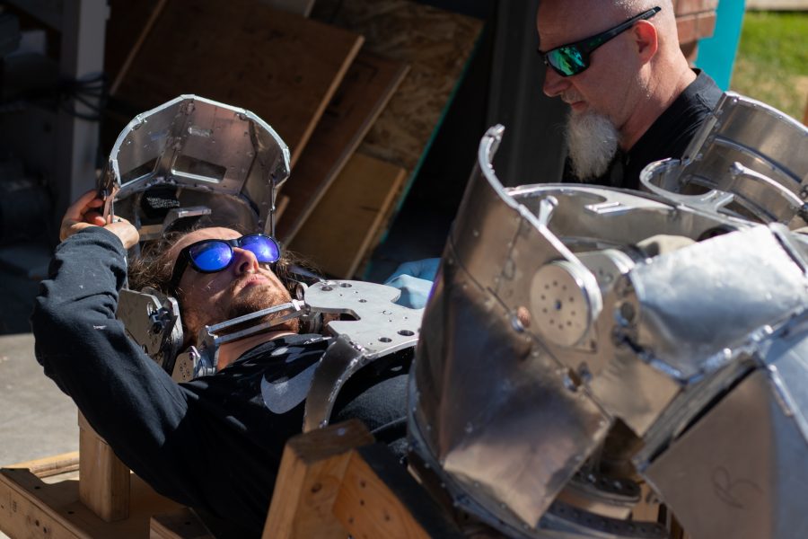 Dylan Edmiston straps into his Mark I Iron Man suit he is designing and manufacturing himself with the help of his father, Robin Edmiston Sept. 19. Edmiston stated, “My goal is to become Iron Man, as much as that is allowed by real world physics, and I want to inspire people by doing so.” (Grayson Reed | The Collegian)