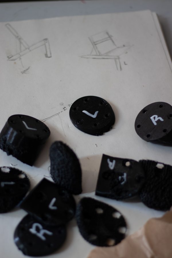 Dylan Edmiston, the designer and manufacturer of a Mark I Iron Man suit, showcases his 3D printed structural components he is crafting himself Sept. 19. These plastic pieces are made to be harder or softer for comfort and structure between the metal exoskeleton and the pilots skeleton. (Grayson Reed | The Collegian)