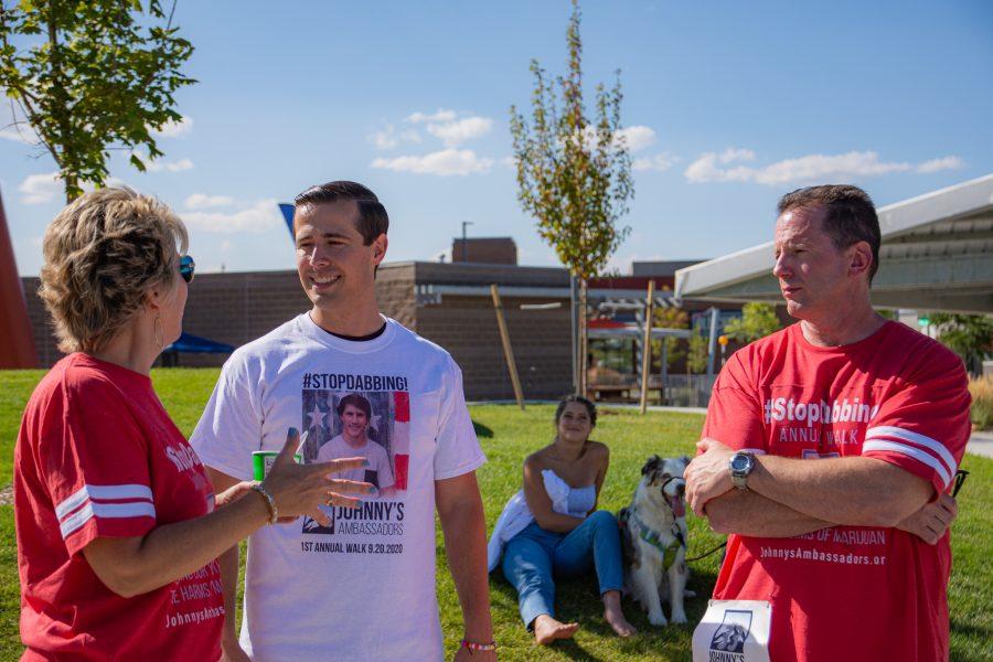 From left to right: Laura Stack, Luke Niforatos and John Stack discuss the ambassadors for Jonnys Ambassadors at Central Park in Highlands Ranch, Colorado, Sept. 19. The parents of Jonny Stack created a community event to help spread awareness of the dangers of marijuana concentrates. (Tri Duong | The Collegian)