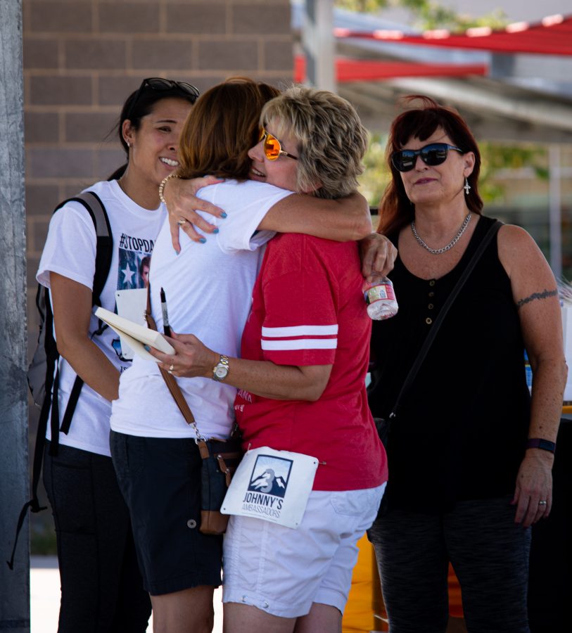 Laura Stack, Hall of Fame Keynote Speaker, hugs a supporter of a Jonnys Ambassadors event at Central Park in Highlands Ranch, Colorado Sept. 19. Stack started group gatherings for parents and local community members to share their experience of having a loved one be affected by marijuana use. (Tri Duong | The Collegian)