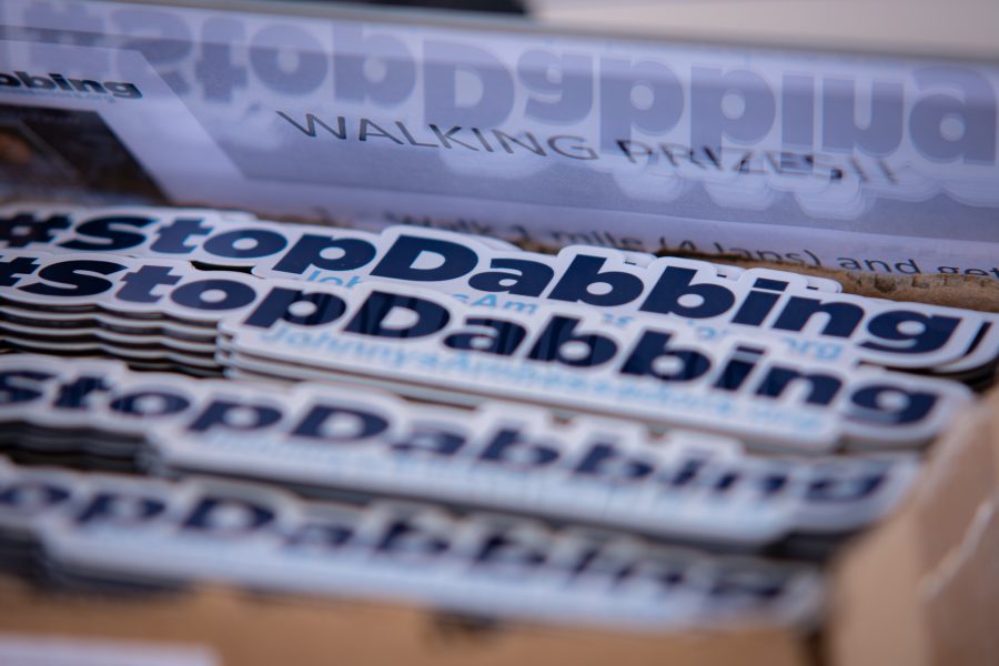 #StopDabbing stickers are available to protestors as prizes after their walk in support of Jonnys Ambassadors at Central Park in Highlands Ranch, Colorado Sept. 19. (Tri Duong | The Collegian)