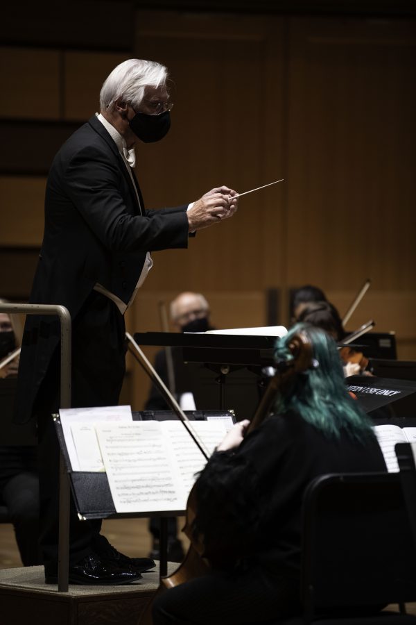 Wes Kenney conducts the Colorado State University Orchestra in their first in person performance in nearly 20 months. The Orchestra was held in the Griffin Concert Hall Sept. 23. (Garrett Mogel | The Collegian)