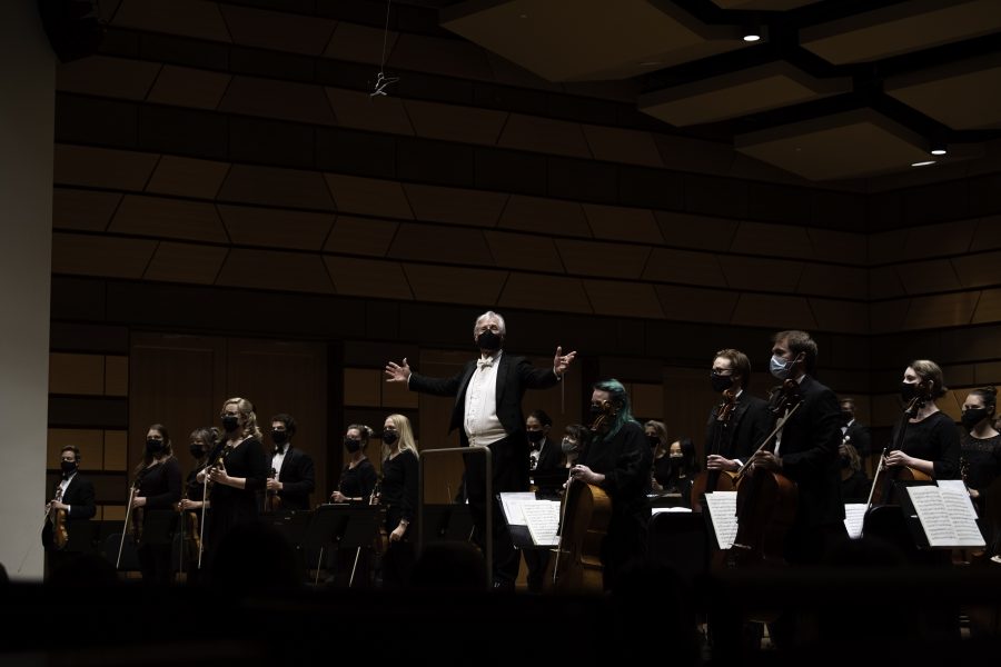 Wes Kenney spreads his arms concluding the Colorado State University Orchestra’s first performance in nearly 20 months Sept. 24. (Garrett Mogel | The Collegian)