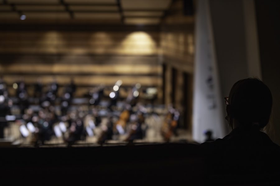 An audience member watches the Colorado State University Orchestra’s first performance in nearly 20 months from the Griffin Concert Hall balcony Sept. 23. (Garrett Mogel | The Collegian)