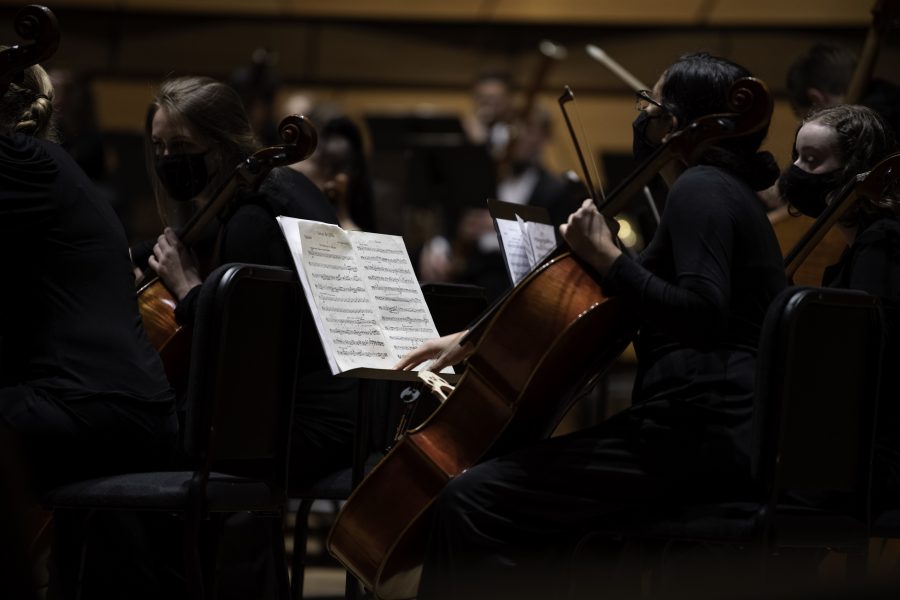 A Colorado State University Orchestra member turns the page of sheet music while performing at the Griffin Concert Hall for the first time in nearly 20 months. Sept. 23. (Garrett Mogel | The Collegian)