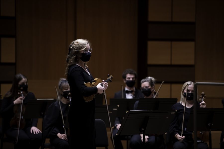 Annie Smith, concertmaster, stands in front of the Colorado State University Orchestra to check tune on instruments. The Orchestra played in front of a live audience for the first time in nearly 20 months at the Griffin Concert hall Sept. 23. (Garrett Mogel | The Collegian)