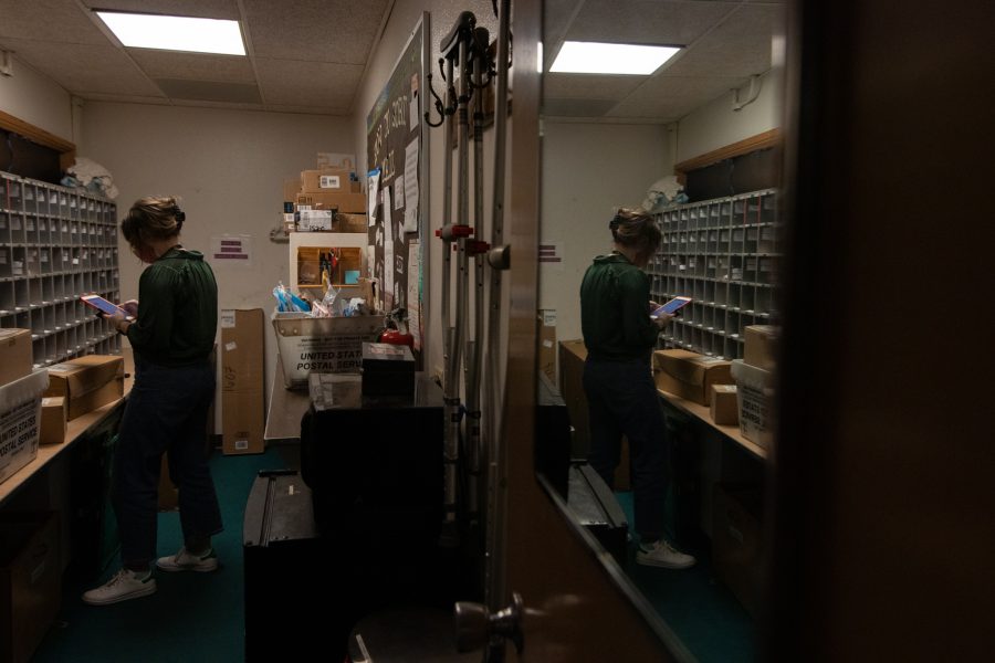 Colorado State University student organizes mail alone in Newsom Hall Sept. 24. (Grayson Reed | The Collegian)