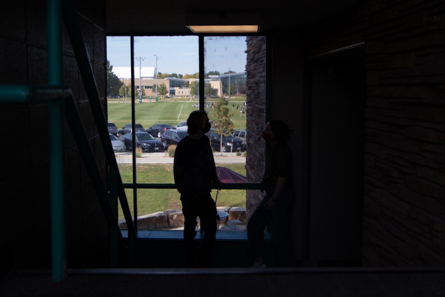 Colorado State University students chat in between buildings in Newsom Hall Sept. 24. (Grayson Reed | The Collegian)
