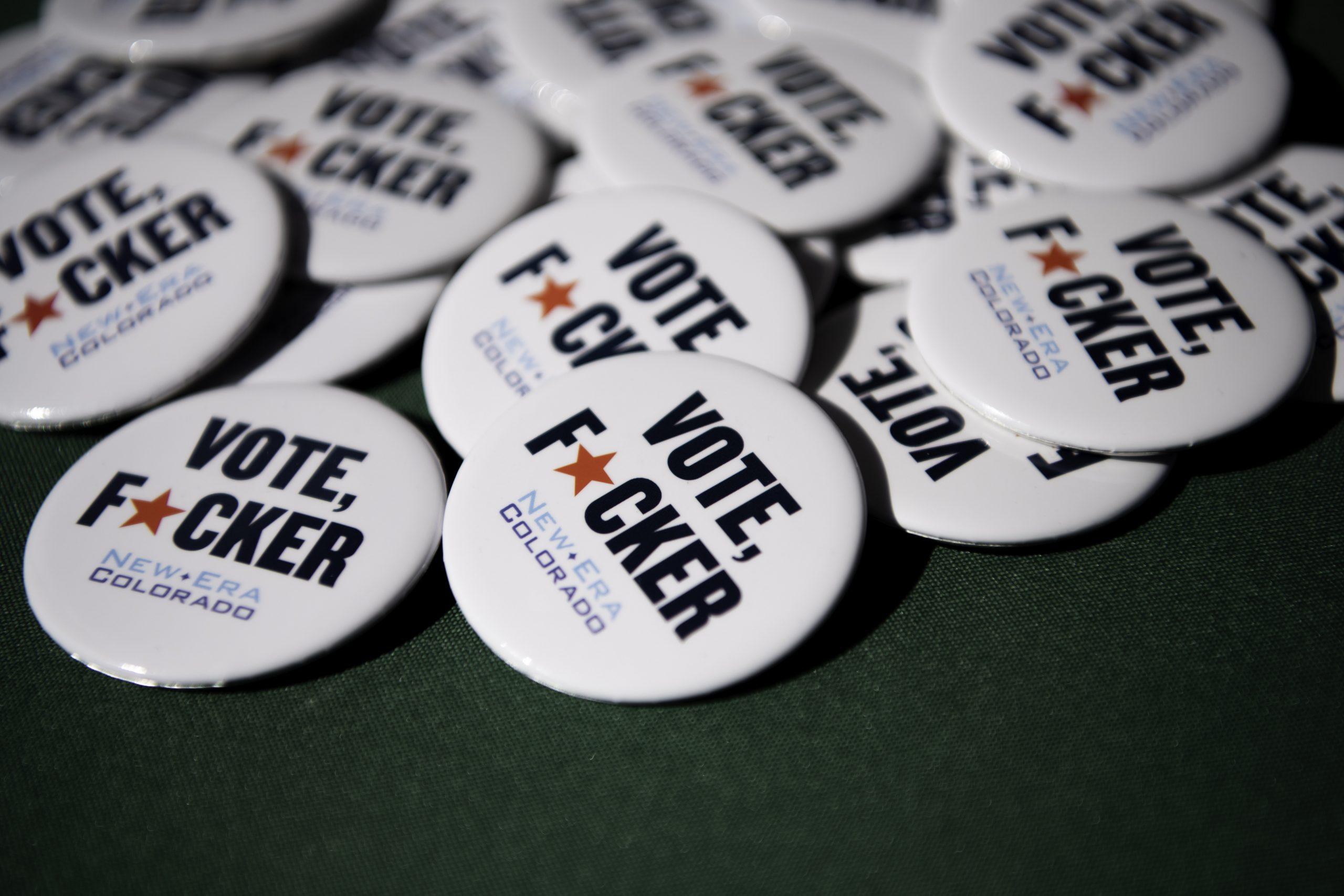 Buttons laid out on voter registration table put up on the Colorado State University Plaza by The Associated Students of Colorado State University Sept. 28. (Garrett Mogel | Collegian)
