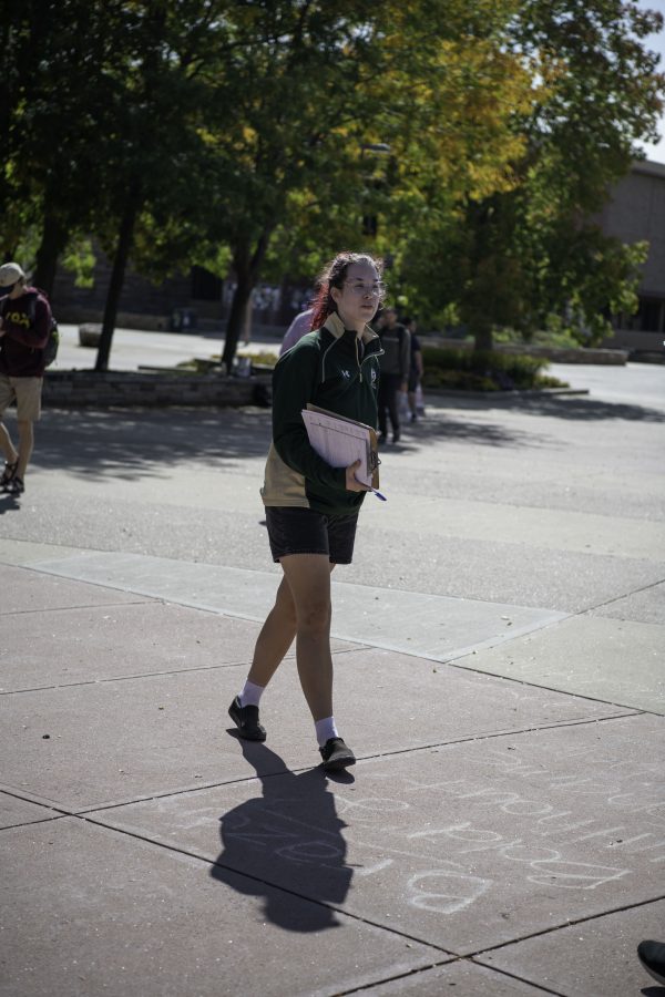 Aly Belknap, senior organizing manager for New Era Colorado walks the Colorado State University Plaza asking students if they are registered to vote. New Era Colorado, The Associated Students of Colorado State University, and the League of Women Voters were out on the CSU Plaza with the goal of helping students register to vote Sept. 28. (Garrett Mogel | The Collegian) 
