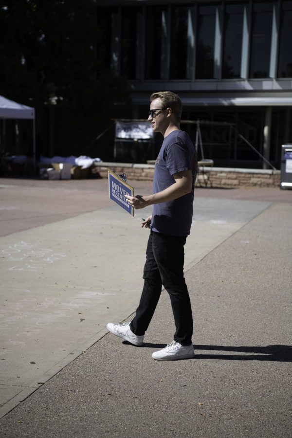 Luke Doescher walks the Colorado State University Plaza as part of the voter registration event put on by The Associated Students of Colorado State University, the League of Women Voters, and New Era Colorado, asking students if they are registered to vote. Doescher stated that his goal was to “Reach out to people without being polarizing and overly political just getting people to vote.” Sept. 28. (Garrett Mogel | The Collegian) 