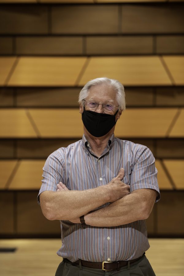 Wesley Kenney, professor at Colorado State University School of Music, Theatre, and Dance, stands on stage in the concert hall in the Center for the arts building. Quote "It has been almost twenty months since we have preformed in front of a live audience. We are so excited... it is who we are."    