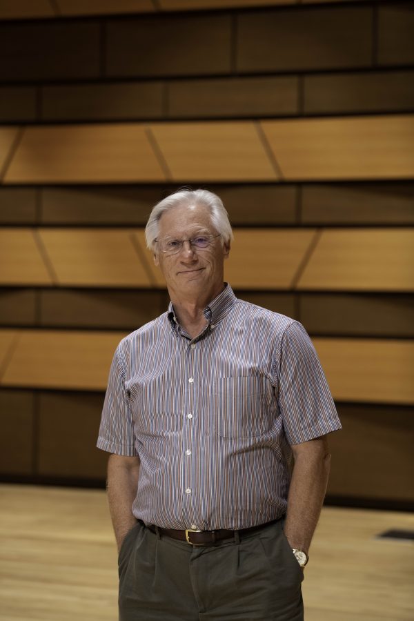 Wesley Kenney, professor at Colorado State University School of Music, Theatre, and Dance, stands on stage in the concert hall in the Center for the arts building. Quote "It has been almost twenty months since we have preformed in front of a live audience. We are so excited... it is who we are."    