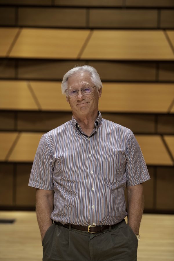Wesley Kenney, professor at Colorado State University School of Music, Theatre, and Dance, stands on stage in the concert hall in the Center for the arts building. Quote "It has been almost twenty months since we have preformed in front of a live audience. We are so excited... it is who we are." 