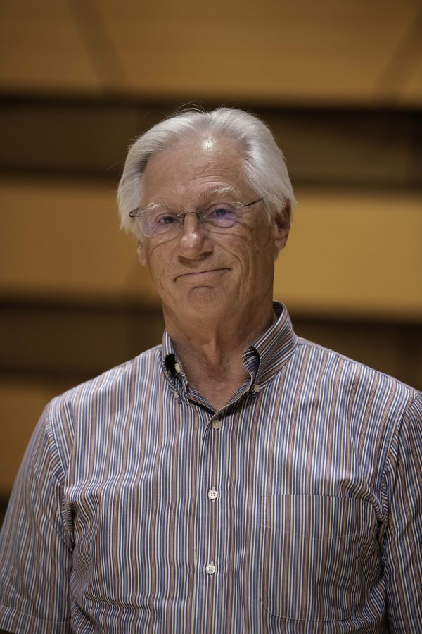 Wesley Kenney, professor at Colorado State University School of Music, Theatre, and Dance, stands on stage in the concert hall in the Center for the arts building. Quote "It has been almost twenty months since we have preformed in front of a live audience. We are so excited... it is who we are."    