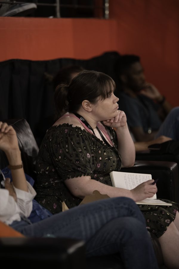 An audience member listens to panelists as they answer their question about musical scores in film. 