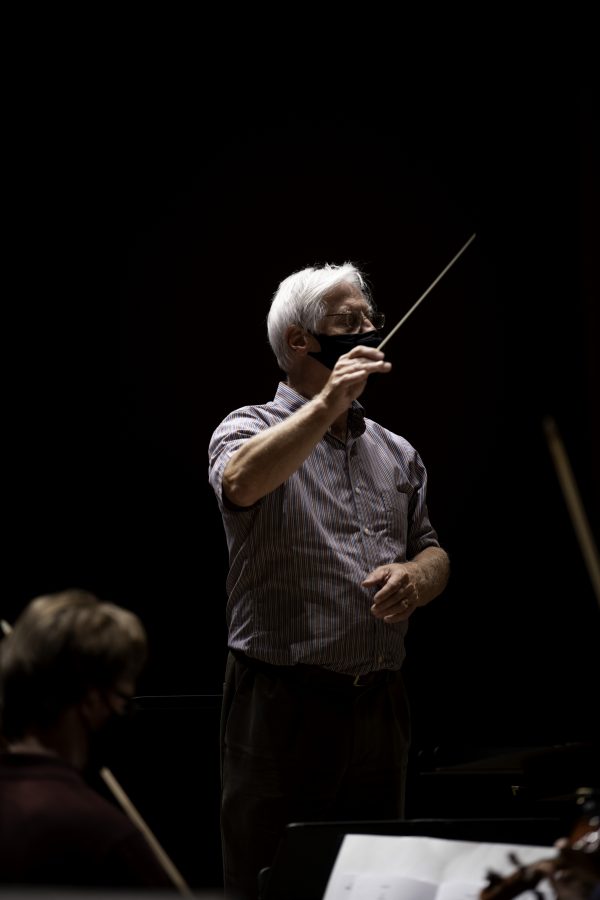 Wesley Kenney, professor and conductor at the Colorado State School of Music, Theatre, and Dance stands before his students baton in hand and prepares them for an upcoming concert to be held in the Edna Rizley Griffin Concert Hall on September 23rd at 7:30pm. Mr. Kenney spoke to the upcoming concert stating that “"It has been almost twenty months since we have performed in front of a live audience. We are so excited... it is who we are."