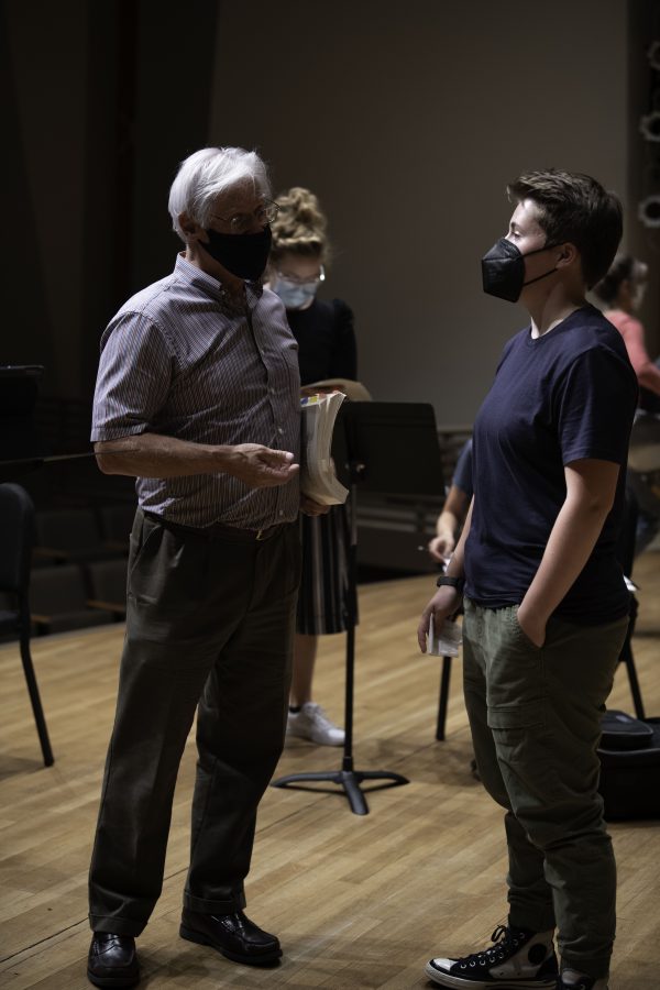 Wesley Kenney speaks with student Shawn Murphy after practice about the music played in class. 
