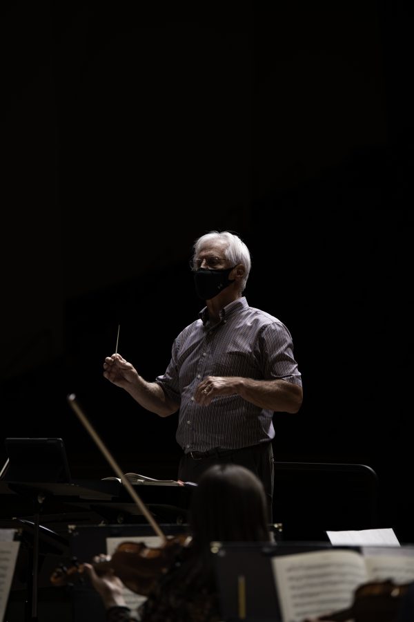 Wesley Kenney, professor and conductor at the Colorado State School of Music, Theatre, and Dance stands before his students baton in hand and prepares them for an upcoming concert to be held in the Edna Rizley Griffin Concert Hall on September 23rd at 7:30pm. Mr. Kenney spoke to the upcoming concert stating that “"It has been almost twenty months since we have performed in front of a live audience. We are so excited... it is who we are." 