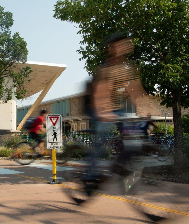 Cyclists pass through the crosswalk outside of the Lory Student Center between classes Sept. 3.