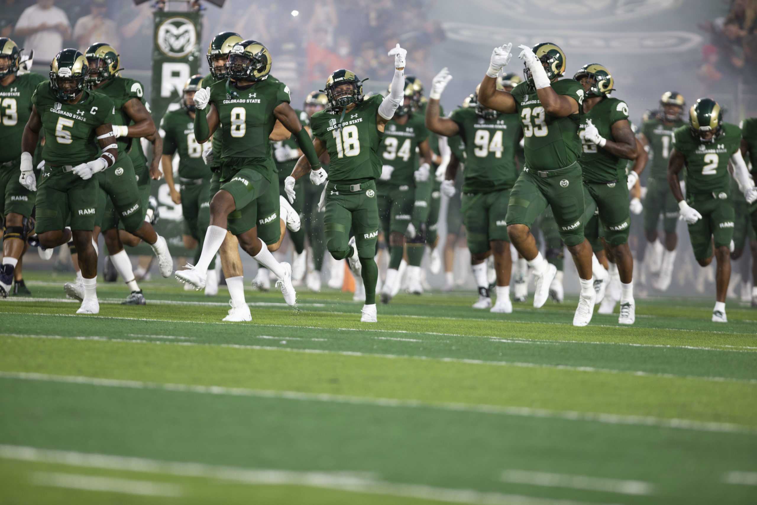 The Colorado State football team taking the field at Canvas Stadium