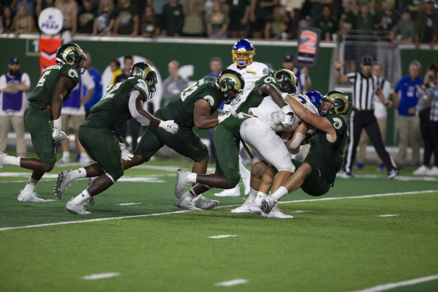 Colorado State Outside Linebacker Scott Patchan (1) along with Defensive back Tywan Francis (8) tackle South Dakota State Quarterback Keaton Heide on Sept. 3. The Rams lost 42-23 against the Jackrabbits. (Gregory James | The Collegian)