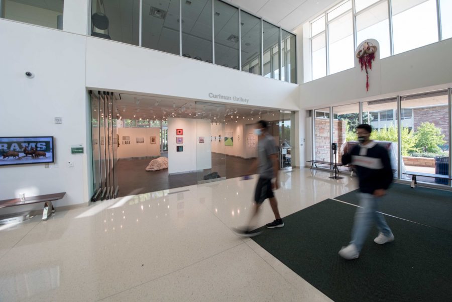 Students walk past the Curfman Gallery in the Lory Student Center at Colorado State University which has an ongoing exhibition titled Some Time Later.  (Pratyoosh Kashyap | The Collegian)