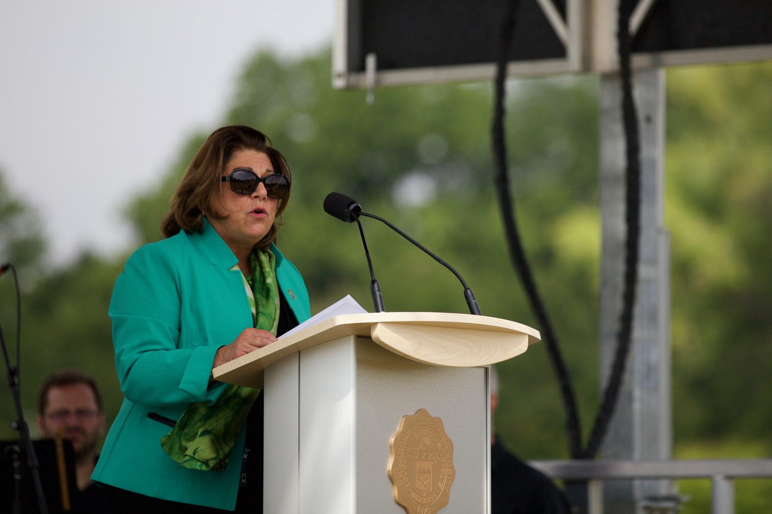 A woman speaks at a podium