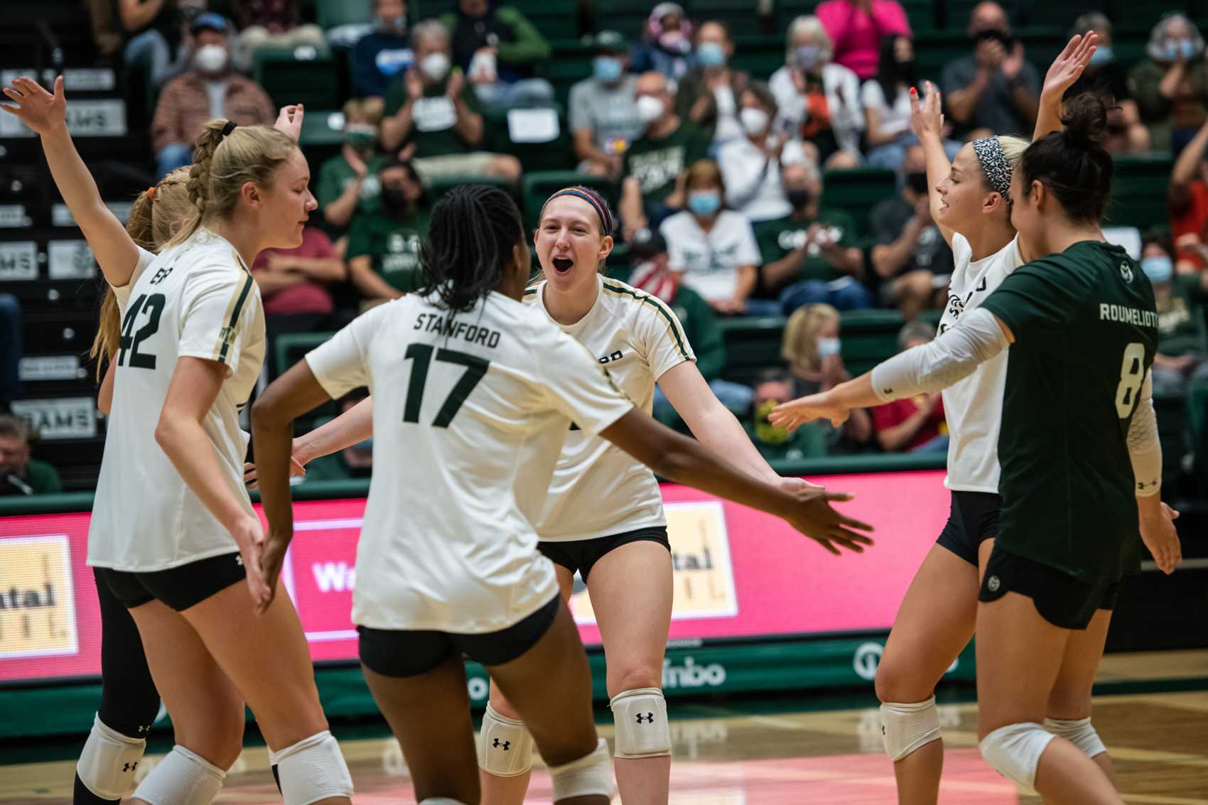 Junior Alyssa Bert celebrates a point with teammates in the first set Sept. 28
