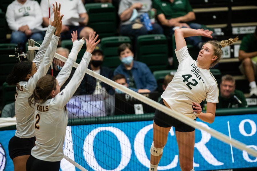 Karina Leber (42) spikes the ball in the Border War against the University of Wyoming Sept. 28. Colorado State University won 3-0. (Lucy Morantz | The Collegian) 