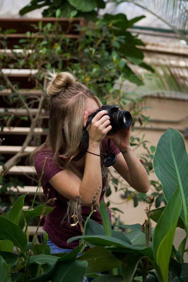 Natalie Coin, English major and member of photography class at Colorado State University practices macro photography techniques inside the conservatory