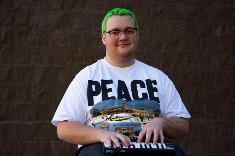 Forrest Nelson, 21 is one of the top eight finalists for the Sonic Spotlight competition, sits outside playing keyboar