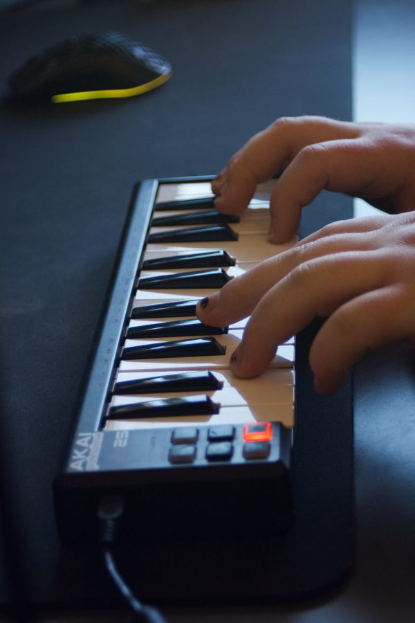 Forrest Nelson, 21 is one of the top eight finalists for the Sonic Spotlight competition, sits at his desk and plays the keyboard for a new song on
