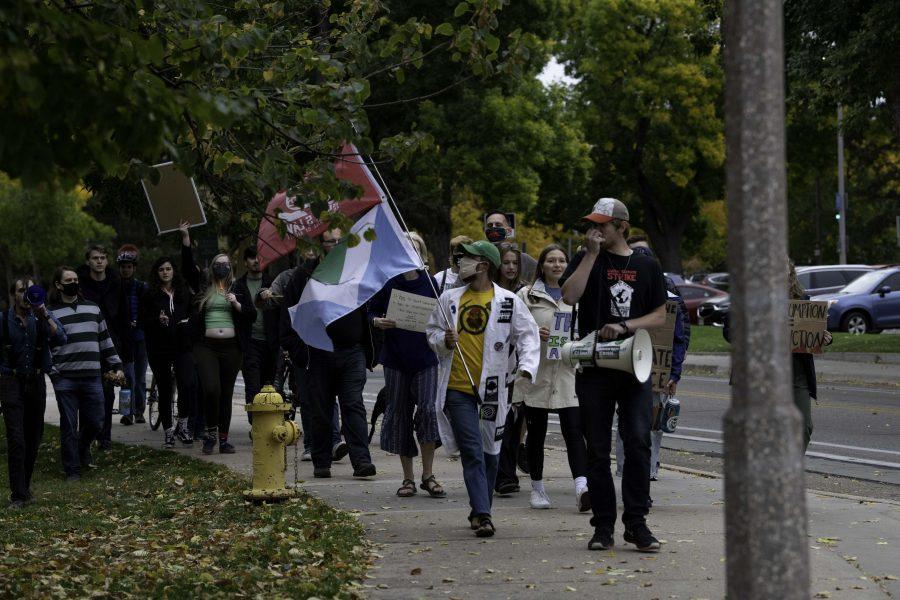 Climate crisis protestors march down West Plum Street toward the Colorado State University Oval chanting “Unionize CSU.” And shouting a call and response of “What do we want? Climate Justice. When do we want it? Now.” Oct. 8. (Garrett Mogel | The Collegian)