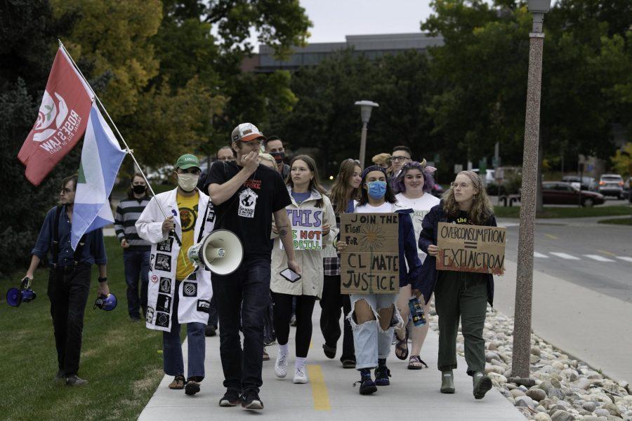 Climate crisis protestors march down West Plum Street toward the Colorado State University Oval chanting “Unionize CSU.” And shouting a call and response of “What do we want? Climate Justice. When do we want it? Now.” Oct. 8. (Garrett Mogel | The Collegian)