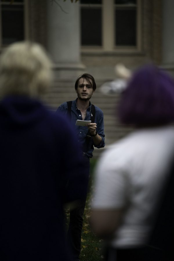 Hunter Linville speaks in front of climate crisis protestors outside the Colorado State University Administration Building about the university’s investments and land grants Oct. 8. (Garrett Mogel | The Collegian)