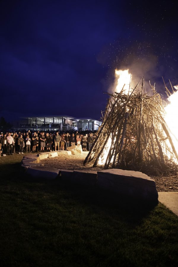 People stand outside the Colorado State University Lory Student Center to watch the homecoming bonfire before the firework display and lighting of the A Oct. 8. (Garrett Mogel | The Collegian)