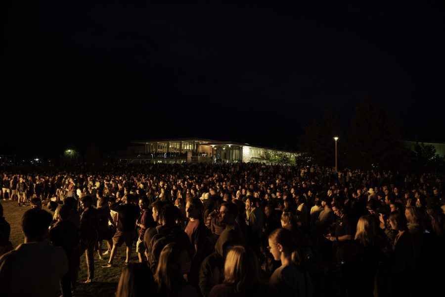 People stand outside the Colorado State University Lory Student Center to watch the homecoming bonfire before the firework display and lighting of the A Oct. 8. (Garrett Mogel | The Collegian)