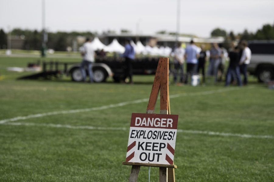 Danger signs line the perimeter of the Colorado State University Intermural Fields as the homecoming firework display is setup Oct. 8. (Garrett Mogel | The Collegian)