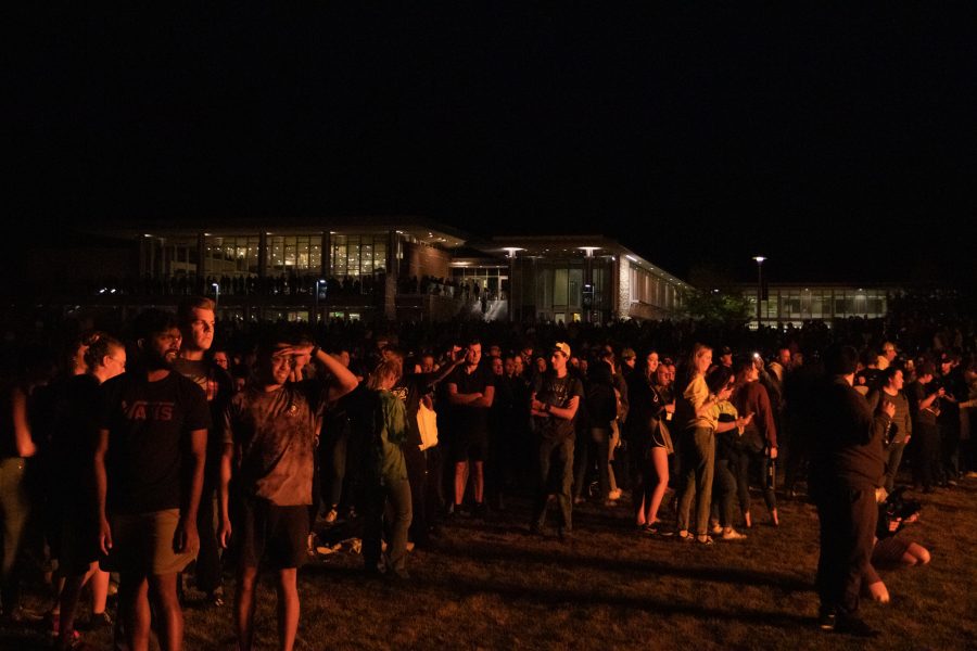 Colorado State University students watch from the West lawn as the bonfire is lit to celebrate Homecoming Oct 08. (The Collegian | Grayson Reed)