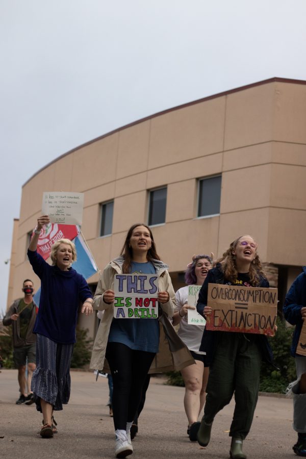 Colorado State University students parade in protest for climate change from Moby Arena to the Administration building Oct. 8. The protest was based around a cleaner campus and the equal pay to the working students who are overburdened. (The Collegian | Grayson Reed)