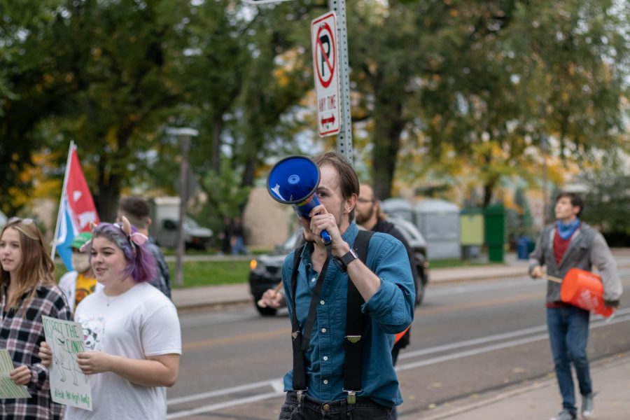 Hunter Linville walks in protest for climate change that started at Moby Arena and finished at the Administration building of Colorado State University Oct 08. The protest was based around a cleaner campus and the equal pay to the working students who are overburdened. (The Collegian | Grayson Reed)
