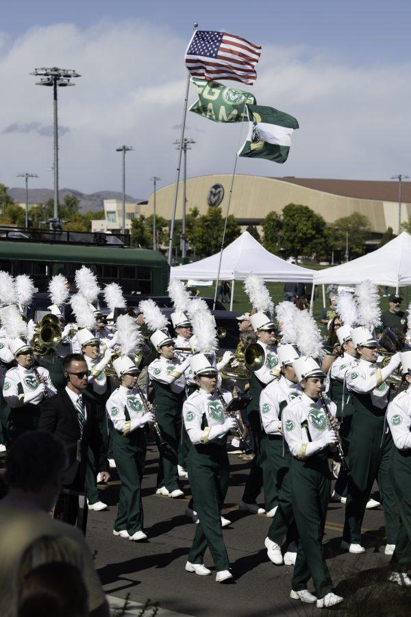 The Colorado State University Marching Band marches past homecoming tailgaters in procession to Canvas Stadium Oct. 9. (Garrett Mogel | The Collegian)