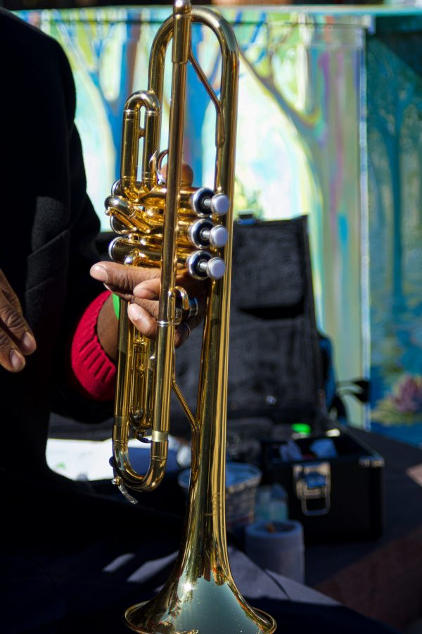 Juan Lee Reed, artist name Fuziion age 43 holds trumpet in Old Town